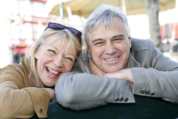 Wall Mural - Senior couple sitting on a public bench