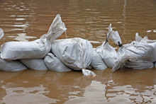 Sandbags For Flood Defense And Brown Water