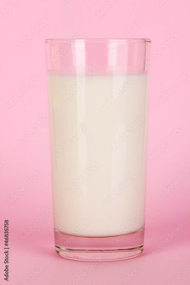 Glass of fresh new milk on pink background