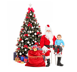 Poster - santa claus and child on his lap posing and a christmas tree