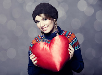 Wall Mural - lovely girl in sweater with toy heart.