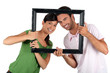 Couple holding empty art frame