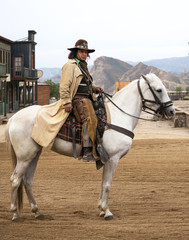 Fototapete - Cowboy Riding his horse at Mini Hollywood, Almeria, Spain