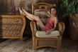 © teplova - Girl sitting on a wicker chair