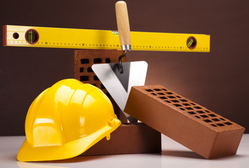 Brick, yellow hard hat, tools