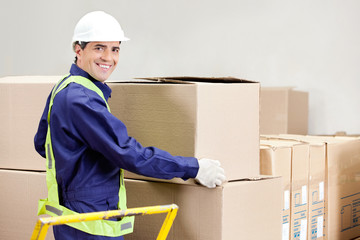 Wall Mural - Foreman Holding Cardboard Box in Warehouse