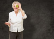 © Krakenimages.com - portrait of senior woman holding kiwi in front of her eye agains