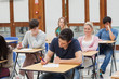 © WavebreakmediaMicro - Students sitting at the exam room writing