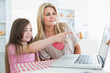 © WavebreakmediaMicro - Child pointing something out on laptop to mother
