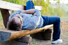 Man Relaxing On Bench