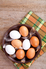 Wall Mural - eggs in a plate, towel and feathers