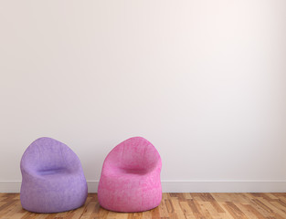 Two poufs near empty wall.