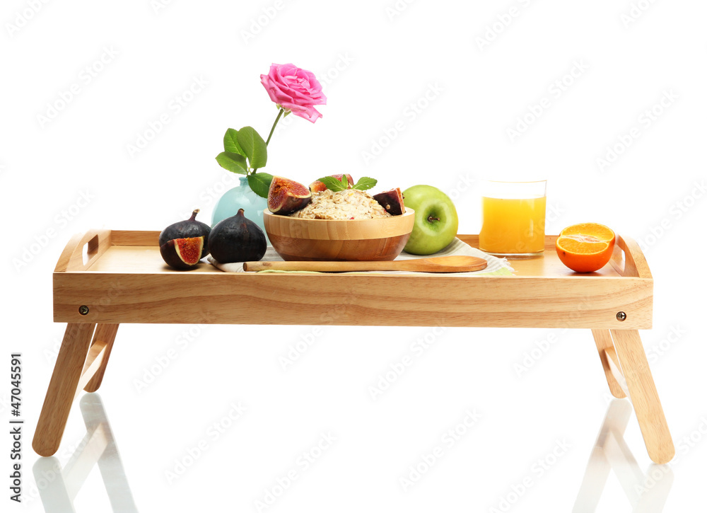 light breakfast on wooden tray isolated on white