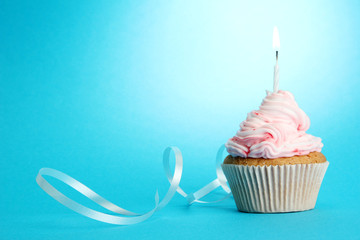 Poster - tasty birthday cupcake with candle, on blue background