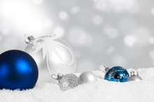 Silver And Blue Christmas Ornaments In Snow