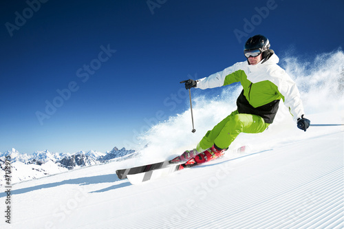 Naklejka dekoracyjna Skier in mountains, prepared piste and sunny day