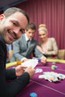 © WavebreakmediaMicro - Man smiling while sitting at poker table