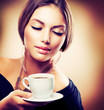 © Subbotina Anna - Beautiful Girl Drinking Tea or Coffee. Sepia Toned