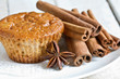 Homemade muffins with cinnamon and anise on plate.