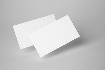 two white blank business cards on gray background