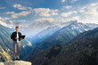 © petunyia - Young businessman using his laptop on the mountain top