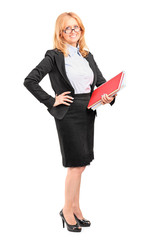 Wall Mural - Smiling female teacher holding a notebook