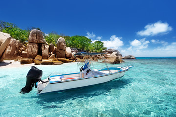 Wall Mural - speed boat on the beach of coco island, seychelles