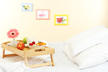 Wall Mural - wooden tray with light breakfast on bed