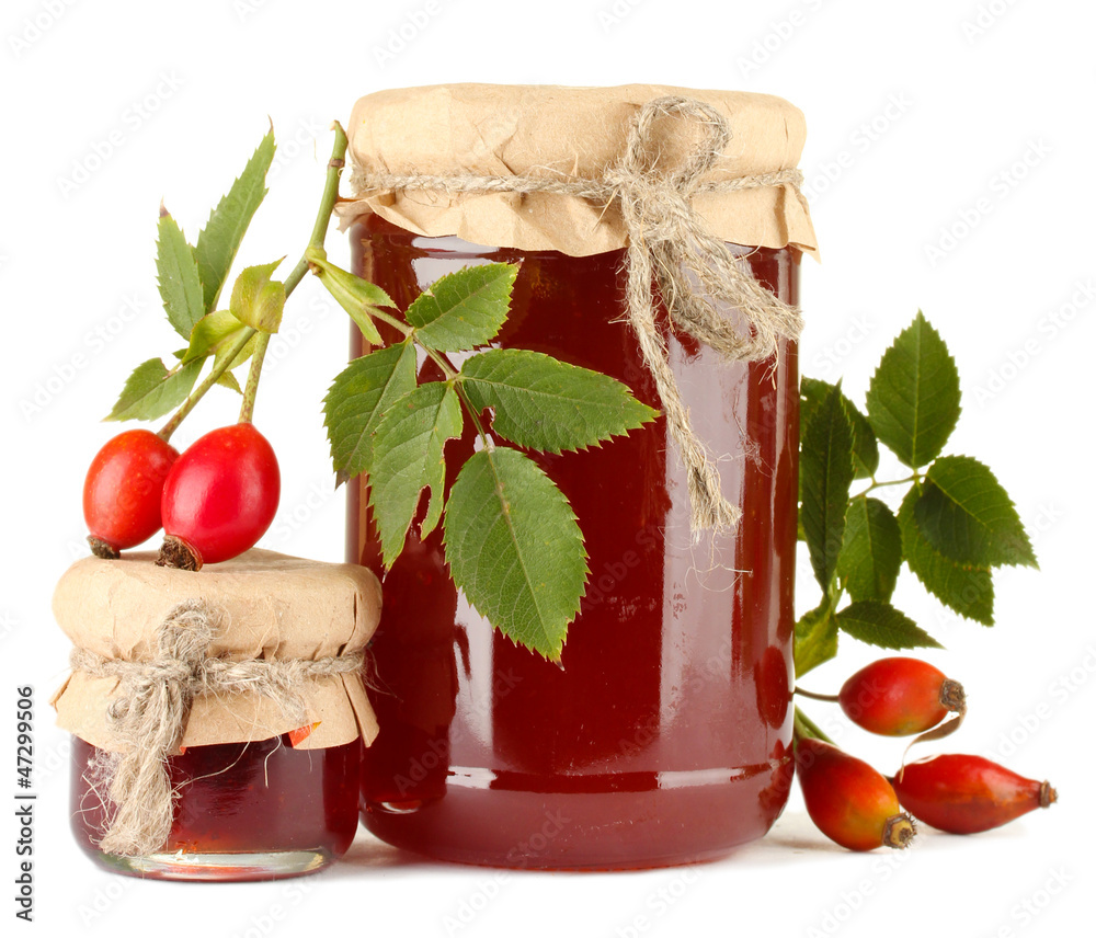 jars with hip roses jam and ripe berries, isolated on white