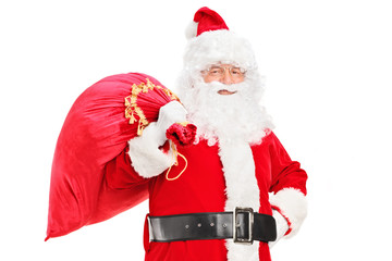 Poster - A Santa Claus posing with a bag full of gifts on his back