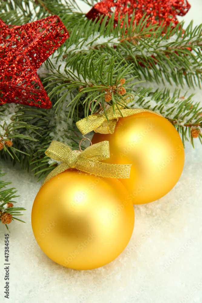 Christmas balls on fir tree with snow, isolated on white