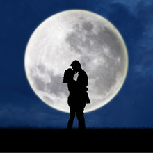Close Up Of Silhouette Couple Kissing On Full Moon