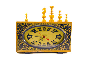 ancient clock and vintage chess figures on white