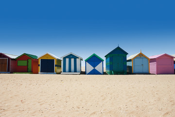 Bright and colorful houses on white sand beach