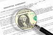 prenuptial agreement , magnifying glass and dollar note