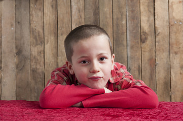 little boy,  head resting on his arms