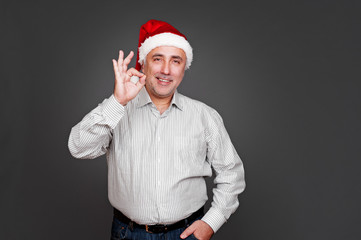 Fototapete - xmas man showing ok sign