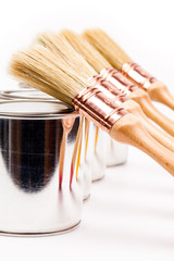 Wall Mural - Cans of paint with paintbrushes  on wooden table