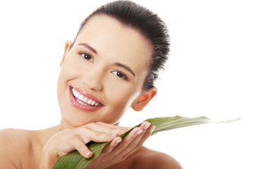 Canvas Print - Young beautiful smiling woman with green leaf