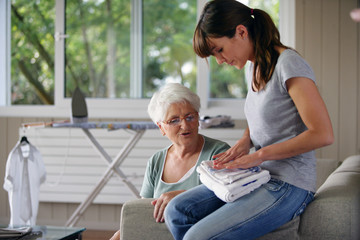 young woman helping senior lady with the housework