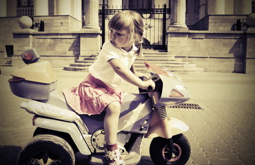 Fotobehang - biker little girl on a motorcycle