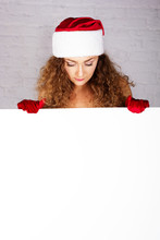 Sexy Young Woman In Christmas Clothes Holding White Board