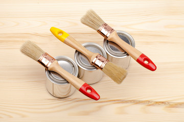 Poster - Cans of paint with paintbrushes on wooden table