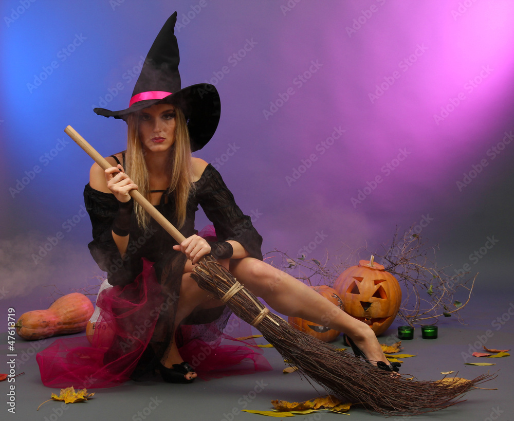 Halloween witch with  broom on color background
