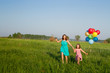 Mother and daughter with multicolored balloons