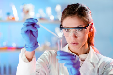 Poster - Attractive young scientist pipetting.