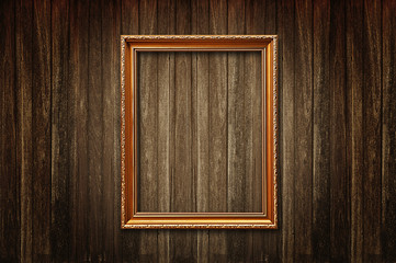 Wall Mural - Golden picture frame on old wooden wall