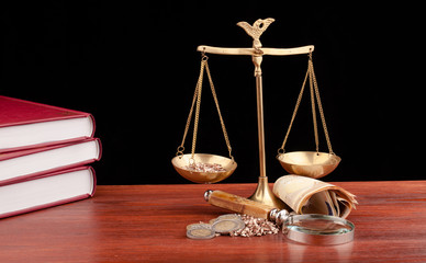 Wall Mural - scale of justice on wooden table and black background