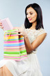 © spass - Beautiful brunette taking out present from shopping bag