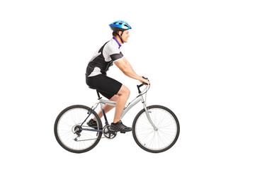 Wall Mural - A young male bicyclist riding a bicycle